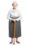 Senior woman with walking stick standing over white