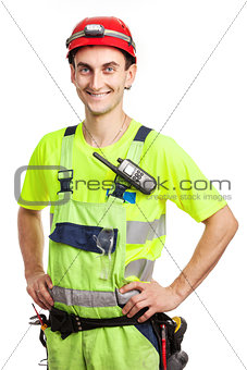 Young handsome contractor in light green uniform. Isolated over white background