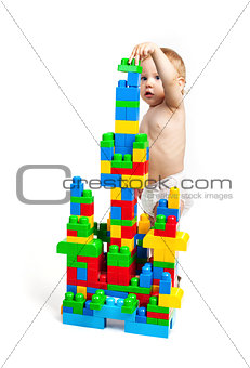 Toddler boy is playing with building blocks