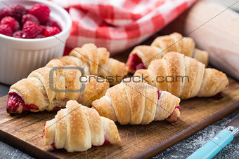 Fresh croissants with raspberries
