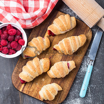 Fresh croissants with raspberries