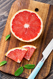 Grapefruit with slices on a table.