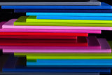 Twelve different colors diaries on a glass desk
