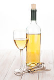 White wine glass, bottle and corkscrew