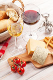 White and red wine glasses, cheese and bread