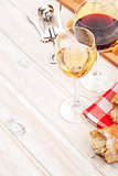 White and red wine glasses, cheese and bread