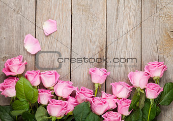 Valentines day background with pink roses over wooden table