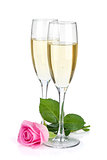 Two champagne glasses and pink rose flower