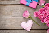 Valentines day background with gift box full of pink roses and h