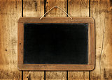 Blackboard on a wood wall background