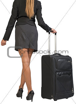 Cropped image of businesswoman with wheeled travel bag makes step forward, back view