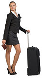 Businesswoman with wheeled travel bag and passport