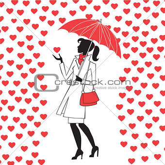 Woman with umbrella under the rain of red hearts