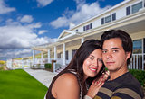 Happy Hispanic Young Couple in Front of Their New Home