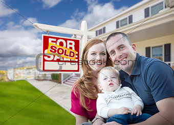 Young Military Family in Front of Sold Sign and House