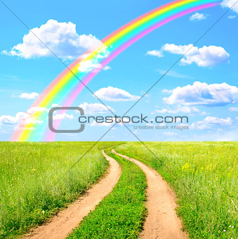 Rural landscape with old road and rainbow