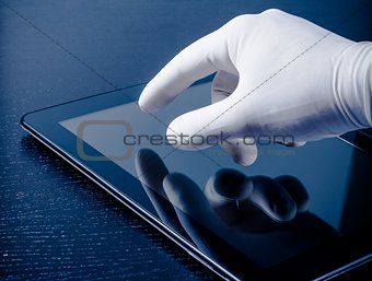 hand in medical glove touching modern digital tablet pc
