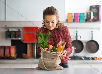 Young housewife enjoying freshness of local market purchases