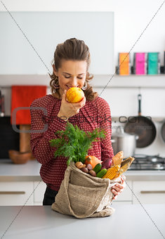 Young housewife with shopping bag of purchases from local market
