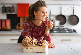 Portrait of happy young housewife with basket with mushrooms in 