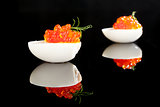 Red caviar in egg with dill isolated.