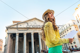 Portrait of happy young woman with map in front of pantheon in r