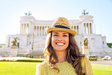 Portrait of happy young woman on piazza venezia in rome, italy