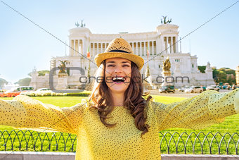 Happy young woman making selfie on piazza venezia in rome, italy