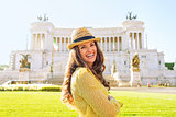 Portrait of smiling young woman on piazza venezia in rome, italy