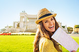 Portrait of smiling young woman with map on piazza venezia in ro