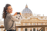 Portrait of happy young woman taking photo of basilica di san pi