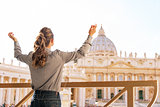 Young woman rejoicing in front of basilica di san pietro in vati