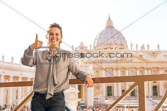 Happy young woman showing thumbs up on piazza san pietro in vati