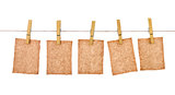 kraft paper hang from clothespins on isolated white background