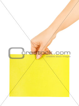 hand holding a yellow paper