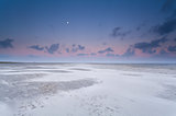 full moon and sunrise sky over sand beach