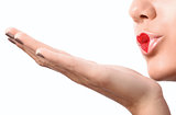 Young girl blowing air kiss with lovely red makeup at the heart shape on her lips
