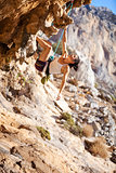 Young female rock climber on a cliff