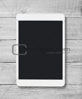 Tablet pc on wood table background