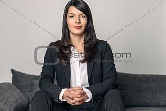 Businesswoman sitting looking at the camera