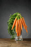 Fresh carrots in a glass vase
