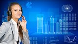 Businesswoman in headset. Skyscrapers beside, hi-tech graphs with various data as backdrop