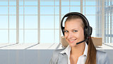 Businesswoman in headset, interior with transparent wall