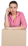 Woman leaning on cardboard box