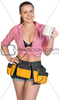 Woman in tool belt showing white mug