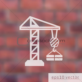 Crane on blurred brick wall