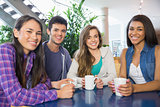 Young students having coffee together