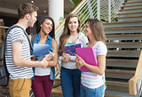 Smiling students chatting together outside