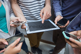Students using tablet pc and their smartphones