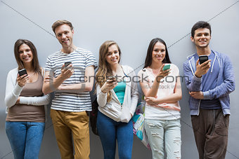Students using their smartphones in a row